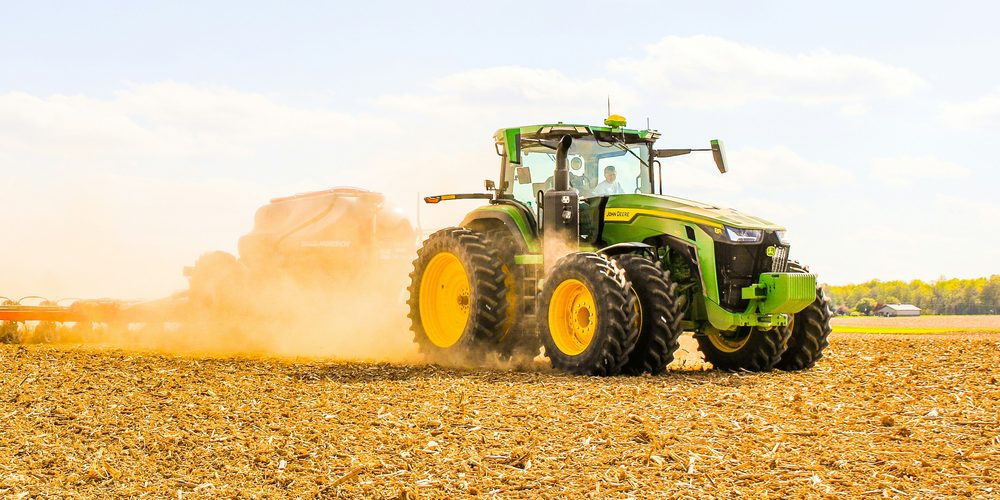 Tractor pulling a seeder in a field
